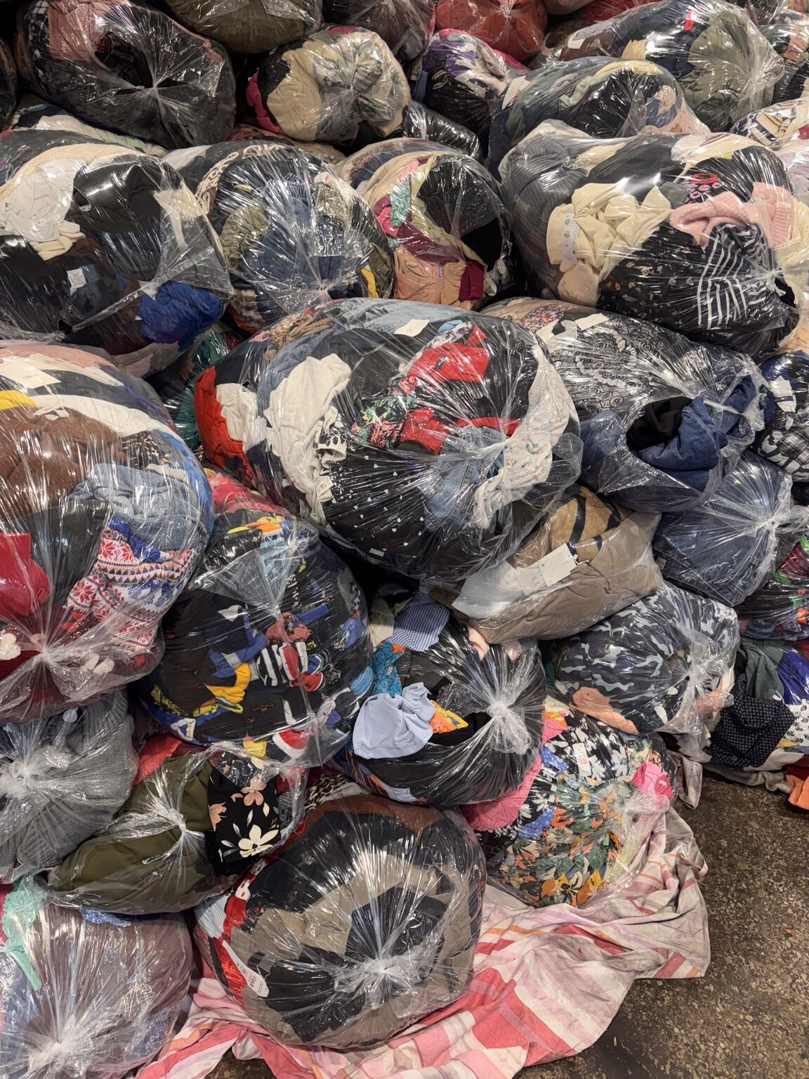 Clothing bundles wrapped in transparent plastic